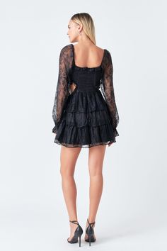 Crafted of intricate floral lace, this mini dress features long sleeves that are finished with ruffle detailing. The corset-style bust has a sweetheart neckline, and the tiered skirt is accentuated with waist cutouts. Floral lace Waist cutouts Elastic at wrists with ruffle detail Corset style bust Bust features stretchy sides Tiered skirt Back zipper with hook-and-eye closure Lined Mini Length Hand wash cold Do not bleach Do not tumble dry Iron low Shell: 100% Nylon Lining: 95% Polyester 5% Span Long Sleeve Lace Dress With Ruffles, Long Sleeve Dress With Ruffled Skirt For Night Out, Long Sleeve Ruffled Skirt Dress For Night Out, Long Sleeve Lace Dress With Ruffle Hem, Mini Lace Dress With Ruffles For Date Night, Night Out Mini Lace Dress With Ruffles, Flirty Long Sleeve Dress With Lace Trim, Long Sleeve Mini Dress With Scalloped Lace For Brunch, Lace Mini Dress With Ruffle Hem And Tiered Design