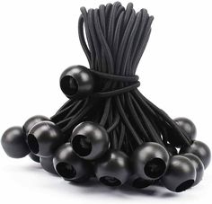 an assortment of black rubber balls on a white background with one string tied around them