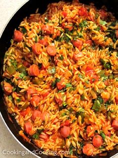 a pan filled with lots of food on top of a table