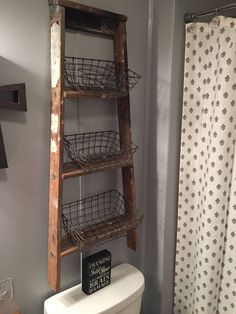 an old ladder used as a shelf for baskets in a bathroom with the caption above it