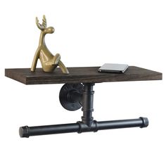 a desk with a laptop on top of it and a gold deer figurine