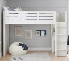 a white bunk bed sitting in a bedroom next to a desk and bookshelf