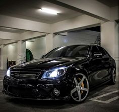 a black car parked in a parking garage