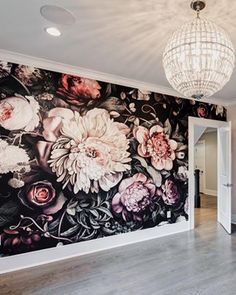 a large floral wallpapered room with a chandelier hanging from the ceiling