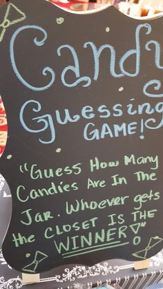 a chalk board sign advertising candy and guess game