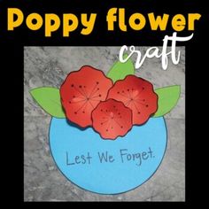 a blue vase filled with red flowers on top of a stone floor next to a sign that says poppy flower craft