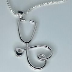 *  Sterling Silver Large Heart Stethoscope Pendant Necklace, Heart Promise Necklace, Silver Love Necklace, Nurse Heart Jewelry, Stethoscope Necklace, Frontline Worker Jewelry, Silver CZ Pendant, Nurse Necklace, Doctor Necklace, Hospital Staff. 925 Stamped *  Perfect gift idea for any occasion: birthday, anniversary, engagement, graduation, bridesmaid, Mother's Day, Valentine's Day, Christmas, Graduation Gift, promise. *  Stethoscopes symbolize a nurse's commitment to care for his patients' healt Cf Lung Necklace, Greys Anatomy Necklace, Stethoscope Pendant, Doctor Necklace, Nurse Necklace, Cute Jewelry Necklaces, Doctor Jewelry, Necklace Gift Ideas, Heart Stethoscope