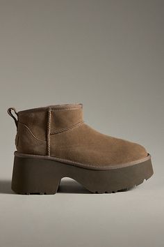 Sheepskin upper, insole Sugarcane EVA sole Pull-on styling Imported | Classic Ultra Mini New Heights Boots by UGG in Brown, Women's, Size: 9, EVA at Anthropologie Classic Mini Regenerate Ugg, Ugg Fluff Mini Quilted Boot, Ugg Mini Or Short, Ugg Ultra Mini Shine, Ultra Mini Ugg Burnt Olive, Camel Chunky Boots, Ugh Platform Mini Boots, Short Tan Ugg Boots, Best Amazon Booties