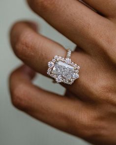 a woman's hand with a diamond ring on it