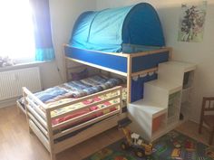 a child's bedroom with bunk beds and toys on the floor, including a toy truck