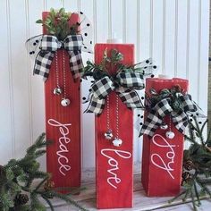 three red wine bottles decorated with black and white ribbon, one has the word love on it