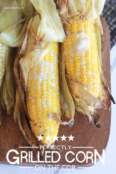 grilled corn on the cob is sitting on a cutting board with text overlay that reads perfectly grilled corn on the cob