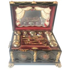 an antique jewelry box with various items in it