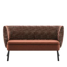 an orange and brown couch sitting on top of a metal frame