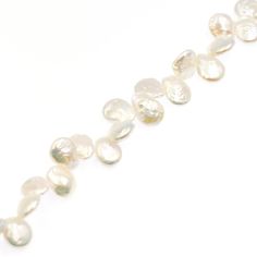 a long strand of white pearls on a white background