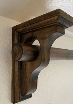 a wooden shelf mounted to the side of a wall