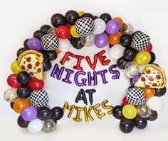 a bunch of balloons that are in the shape of a wreath with words five nights at mike's