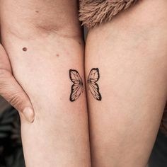 two tattoos on the legs of women with butterfly wings tattooed on each side of their thighs