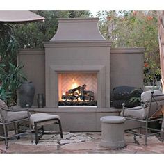 an outdoor fireplace surrounded by chairs and tables