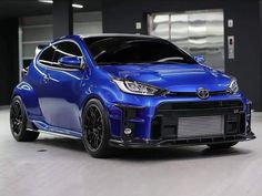 a blue car parked in a parking garage