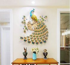 a peacock clock mounted on the wall above a table