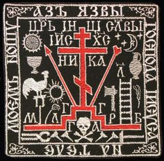 a cross with symbols on it in red and black