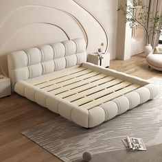 a white bed sitting on top of a wooden floor