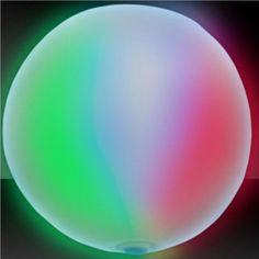 an image of a colorful ball in the dark with light coming from it's center