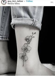 a woman's foot with a flower tattoo on the left side of her leg