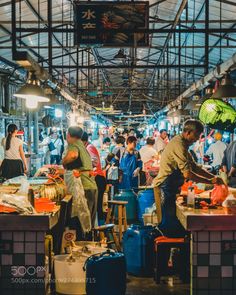 people are shopping at an indoor market