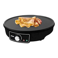 an electric skillet with some food on it