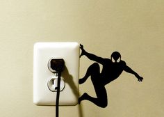 an electrical outlet with a wall sticker depicting a soccer player kicking the ball,