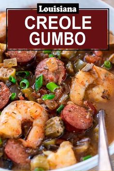 a white bowl filled with shrimp and sausage gumbo next to a spoon on top of a wooden table