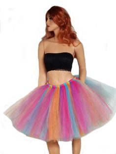 Step into the spotlight with our bold and daring custom-made neon-colored tutu skirt! Each skirt is meticulously crafted to order, ensuring a perfect fit and attention to detail that will make you stand out from the crowd. Constructed with care, this eye-catching skirt features strips of vibrant tulle tied securely to an elastic waistband. The result? A stunning masterpiece that's as comfortable as it is stylish. Available in a range of electrifying colors, including Orange, Green Apple, Purple, Fuchsia, and Turquoise, you'll have no trouble finding the perfect hue to suit your mood and personality. For adults and kids sizes 16-20, the skirt measures a chic 20 inches in length, while smaller children can enjoy a playful knee-length version that's just as fabulous. Whether you're hitting th Multicolor Skirt For Costume Party, Neon Color, Tutu Skirt, Green Apple, Knee Length, Womens Skirt, Perfect Fit, Bathing Beauties, Neon