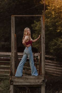 a woman standing on top of a wooden structure