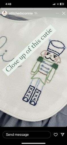 an embroidered bib with the words close up of this cute little boy on it