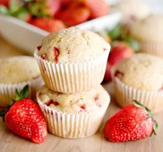 strawberries and muffins on a wooden table