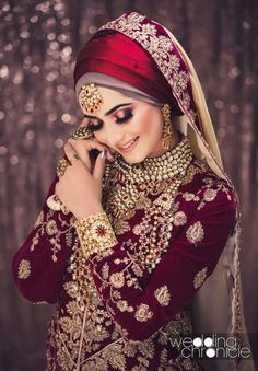 a woman in a red and gold wedding outfit