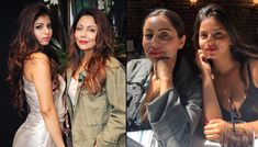 three women are posing for pictures in front of a brick wall and one is holding a drink