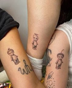 two girls with matching tattoos on their arms