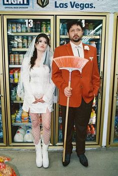 a man and woman dressed up as bride and groom in front of vending machines