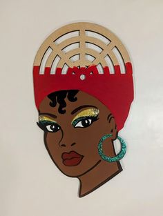 a paper cut out of a woman wearing a red headdress and hoop earrings