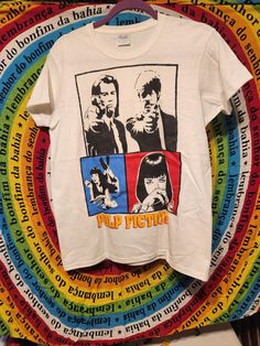 a white t - shirt with the words pulp fiction printed on it and an image of two men