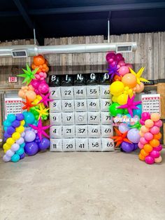 balloons and numbers are on display in front of a calendar