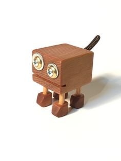 a wooden toy with two eyes on it