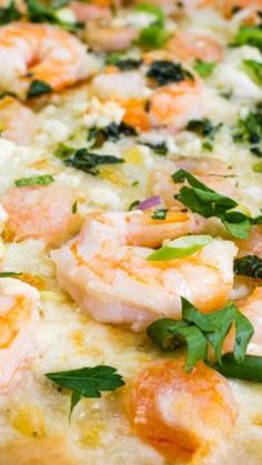 a pizza with shrimp, cheese and herbs on it's crust is seen in this image