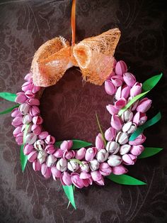 a wreath made out of tulips and other flowers on a brown tablecloth