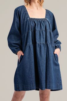 this classic, tiered denim long sleeve dress is crafted from soft, high-quality cotton. it features a flattering square neckline and long sleeves with gathered cuffs for a relaxed yet timeless look. the tiered design adds a playful touch, creating a flowy silhouette that's perfect for any occasion. with practical side pockets, this dress combines comfort and fashion seamlessly. dress it up with statement jewelry or keep it casual with your favorite sneakers for a versatile wardrobe staple. 100% Long Sleeve Denim Dress With Ruffles, Long Sleeve Cotton Denim Dress, Spring Denim Dress With Square Neck, Spring Square Neck Denim Dress, Relaxed Fit Long Sleeve Denim Dress, Medium Wash Denim Dress With Square Neck, Long Sleeve Medium Wash Cotton Dress, Long Sleeve Denim Dress With Relaxed Fit, Denim Blue Long Sleeve Dress With Relaxed Fit