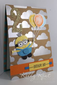 a birthday card with a minion holding balloons and the number two on it's side