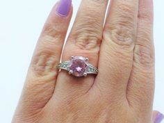 Vintage Solid Sterling Silver Pink and Clear Stones Engagement Ring, 1960s, Good Condition, Size 7, Vintage Pink Diamond Ring Hallmarked, Vintage Pink Diamond Ring With Hallmark, Pink Amethyst Ring With Accent Stones, Pink Sterling Silver Ring With Stone Setting, Pink Crystal Ring With Accent Stones, Round Cut, Pink Round Cut Crystal Ring With Accent Stones, Pink Jewelry With Round Center Stone, Hallmarked Pink Round Rings, Vintage Pink Round Diamond Ring